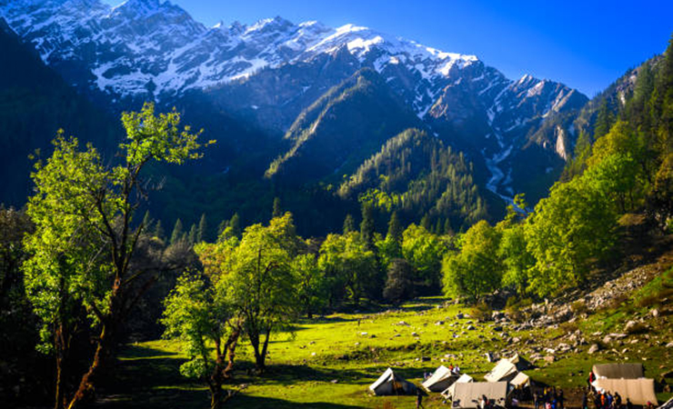 Mountain landscape with green grass, meadows scenic camping Himalayas peaks & alpine from the trail of Sar Pass trek Himalayan region of Kasol, Himachal Pradesh, India.